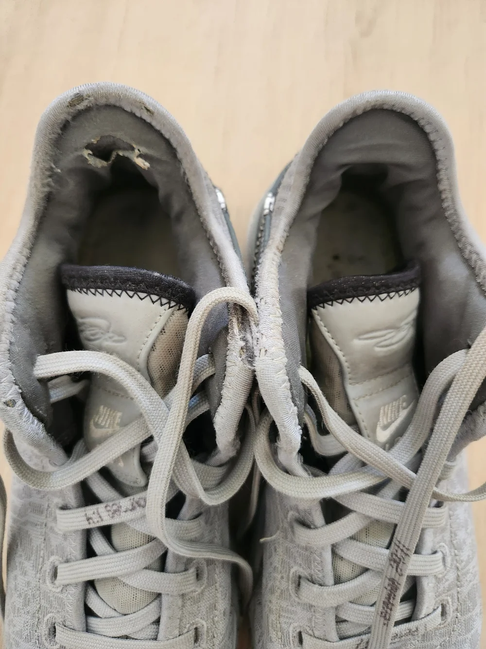 Nike Gray and White Low-Top Sneakers with Gold Swoosh